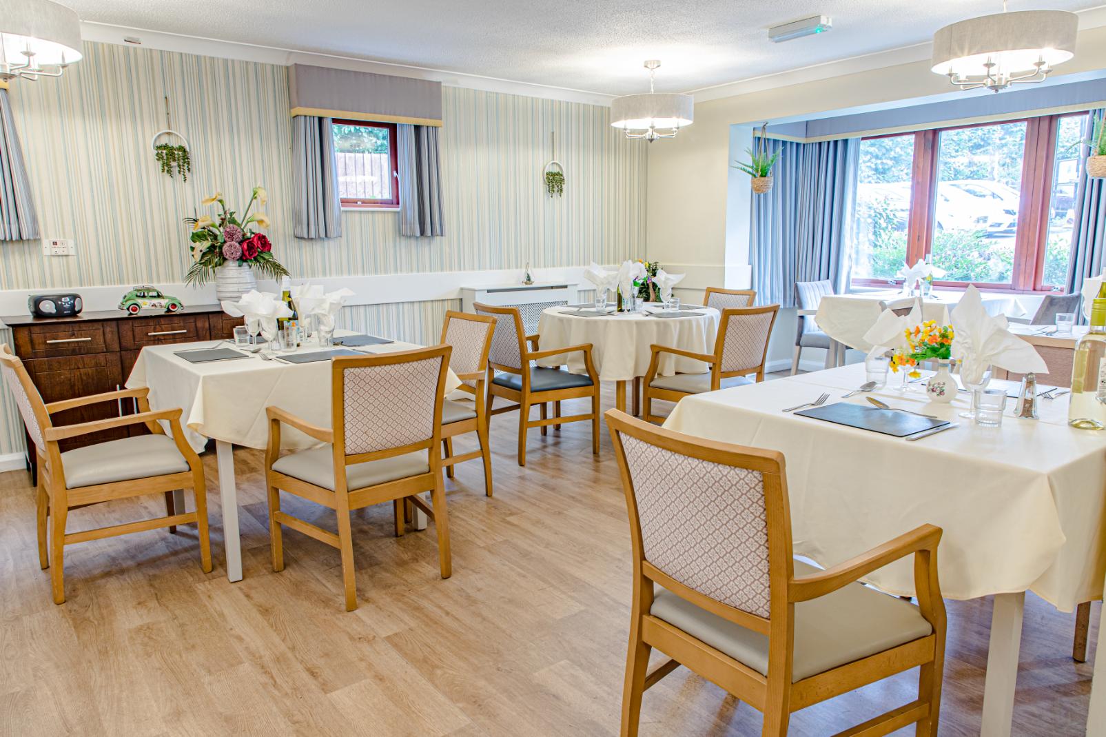 dining area with tables and two windows